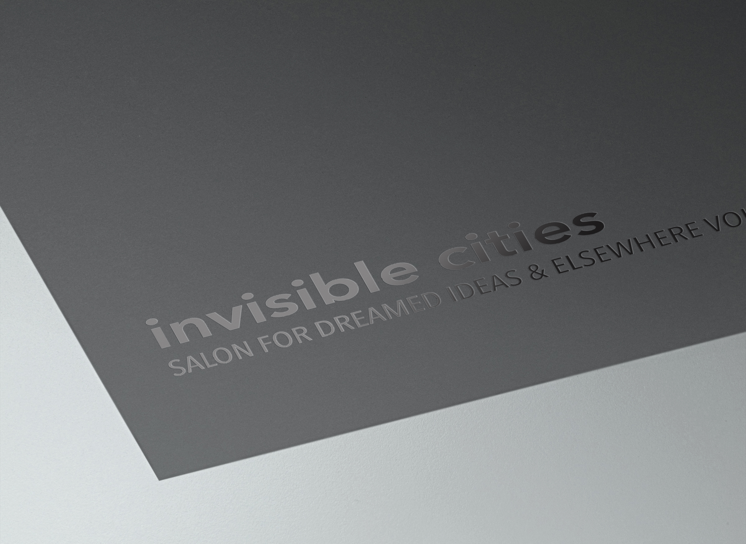 Close-up detail of Invisible Cities Salon logo varnished on business card